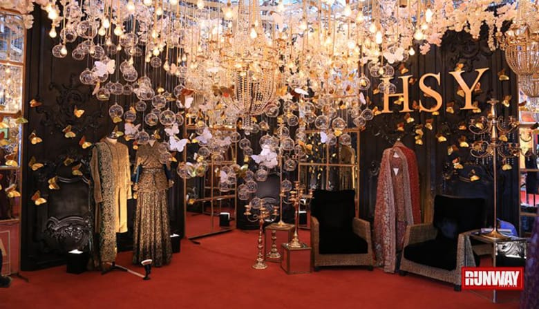 bridal show boutique with large chandelier sparkly and red carpet