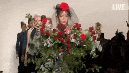 Wedding Day Don't #12 - GIF of runway model walking wearing a dress made of flowers