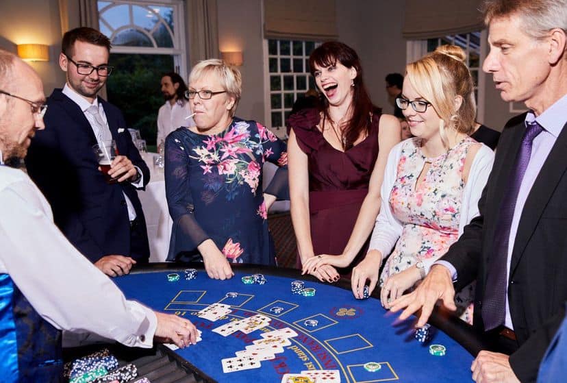 Blackjack casino table at a wedding reception with wedding guests