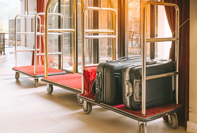 wedding-guest-appreciation-hotel-choices-suitcases-on-baggage-cart
