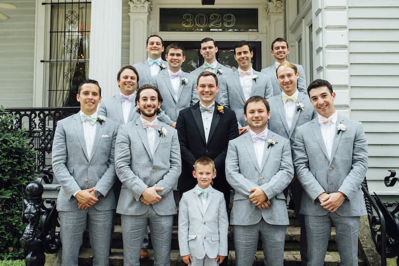 White wedding groomsmen grey suits pastel colored bow ties